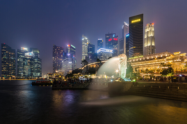 Merlion Statue at twilight with Singapore skyscrapers in background